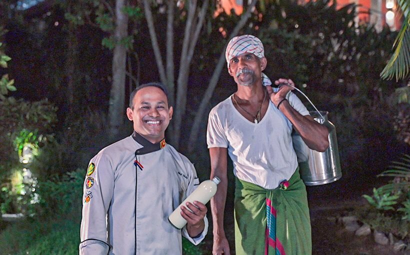 Aarunya chef with a local dairy farmer carrying a milk can